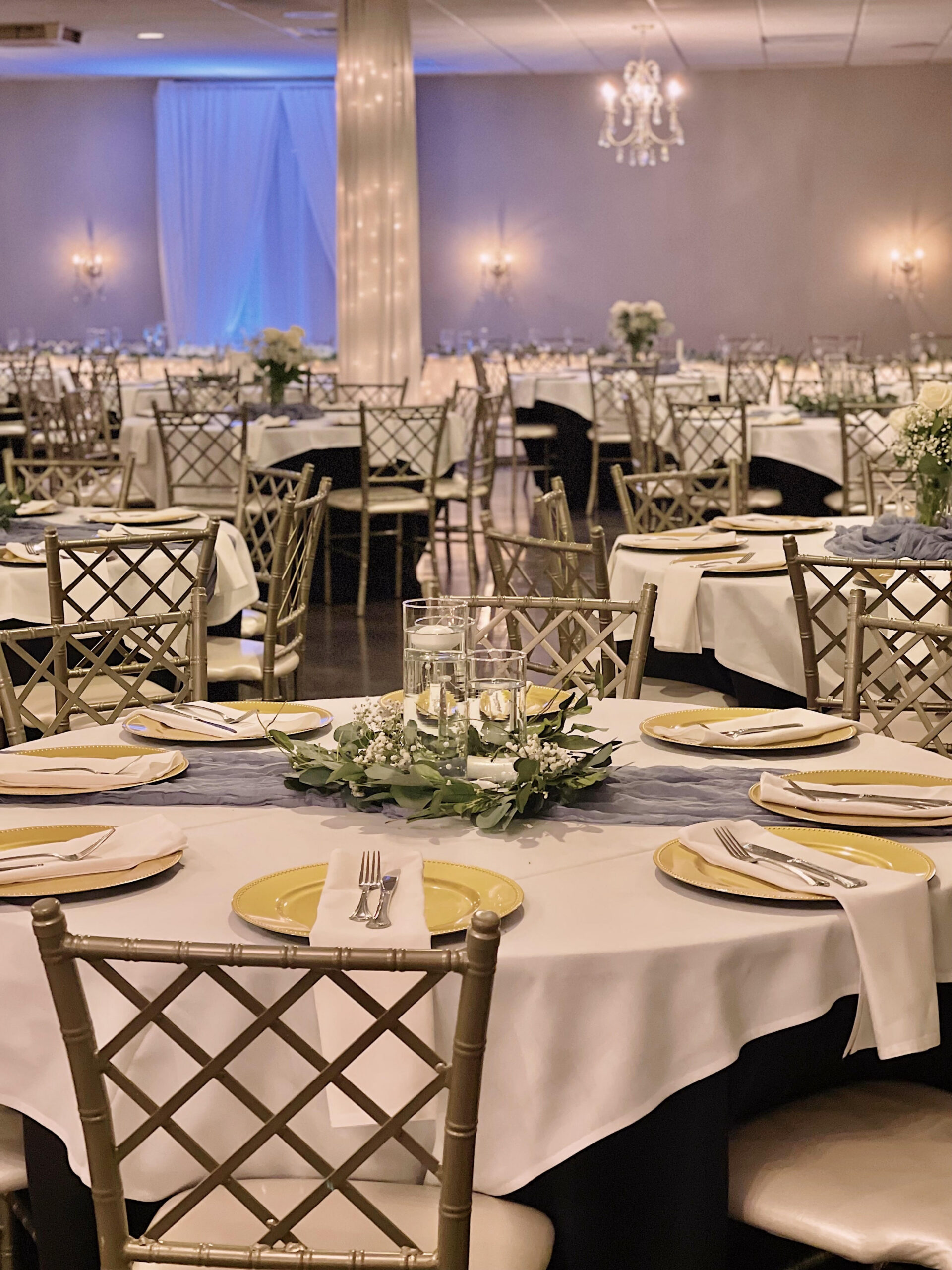 Ballroom set with gold chargers and garden centerpieces